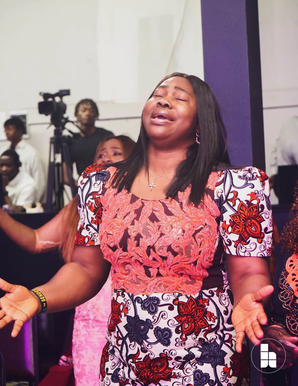 A member worshipping with arms open