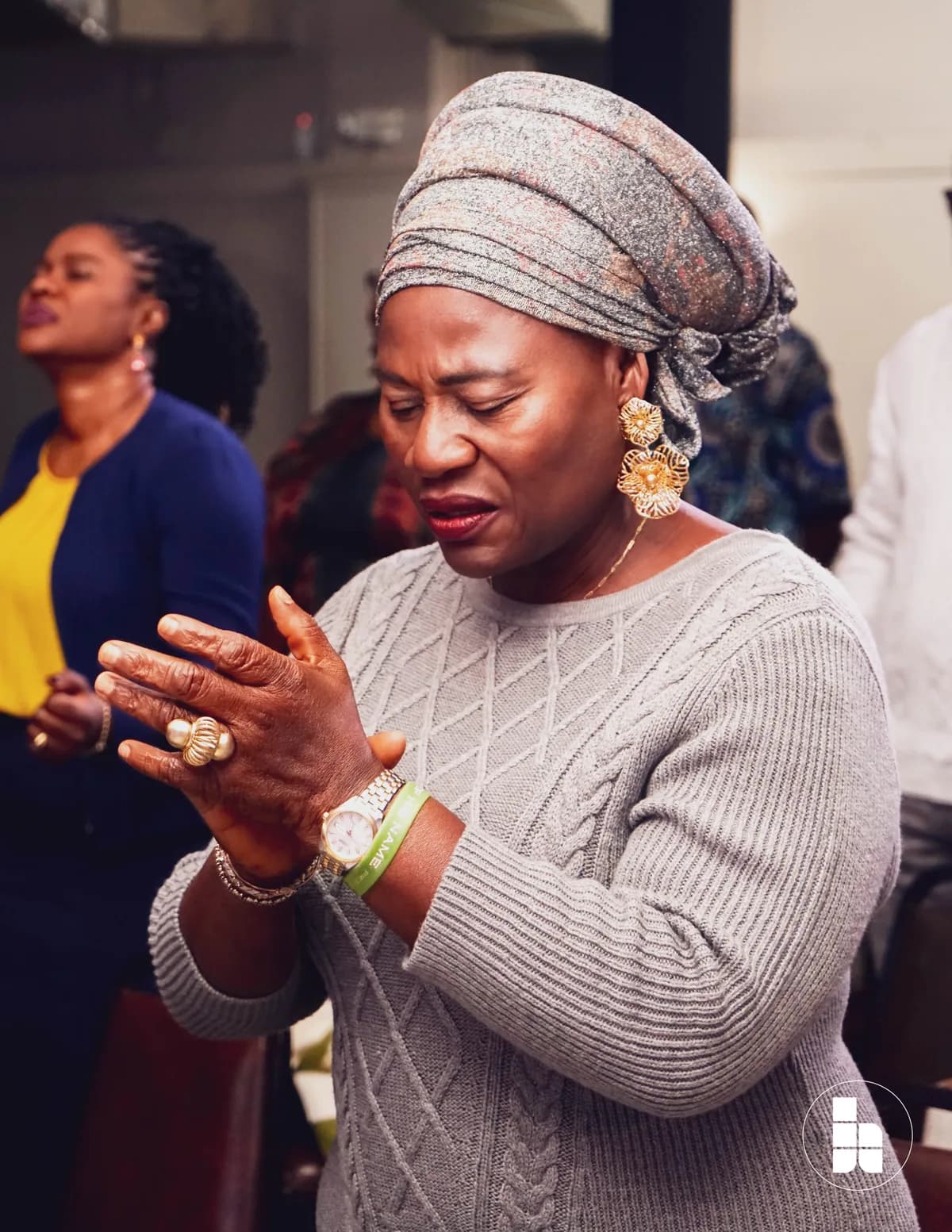 A member praying during a Sunday service