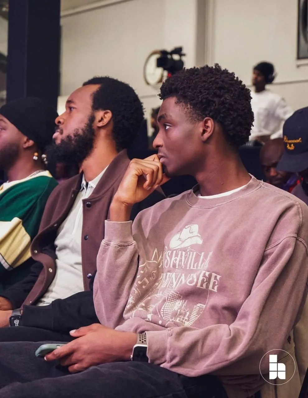 Two young men listening during a service