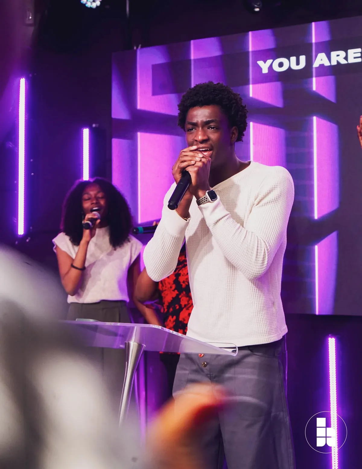 A young man leading a song during worship