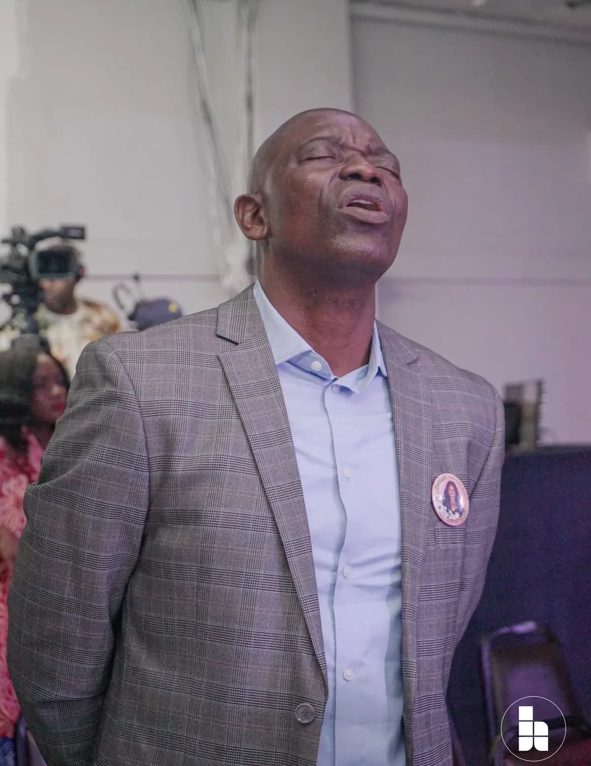 A member worshipping with his eyes closed