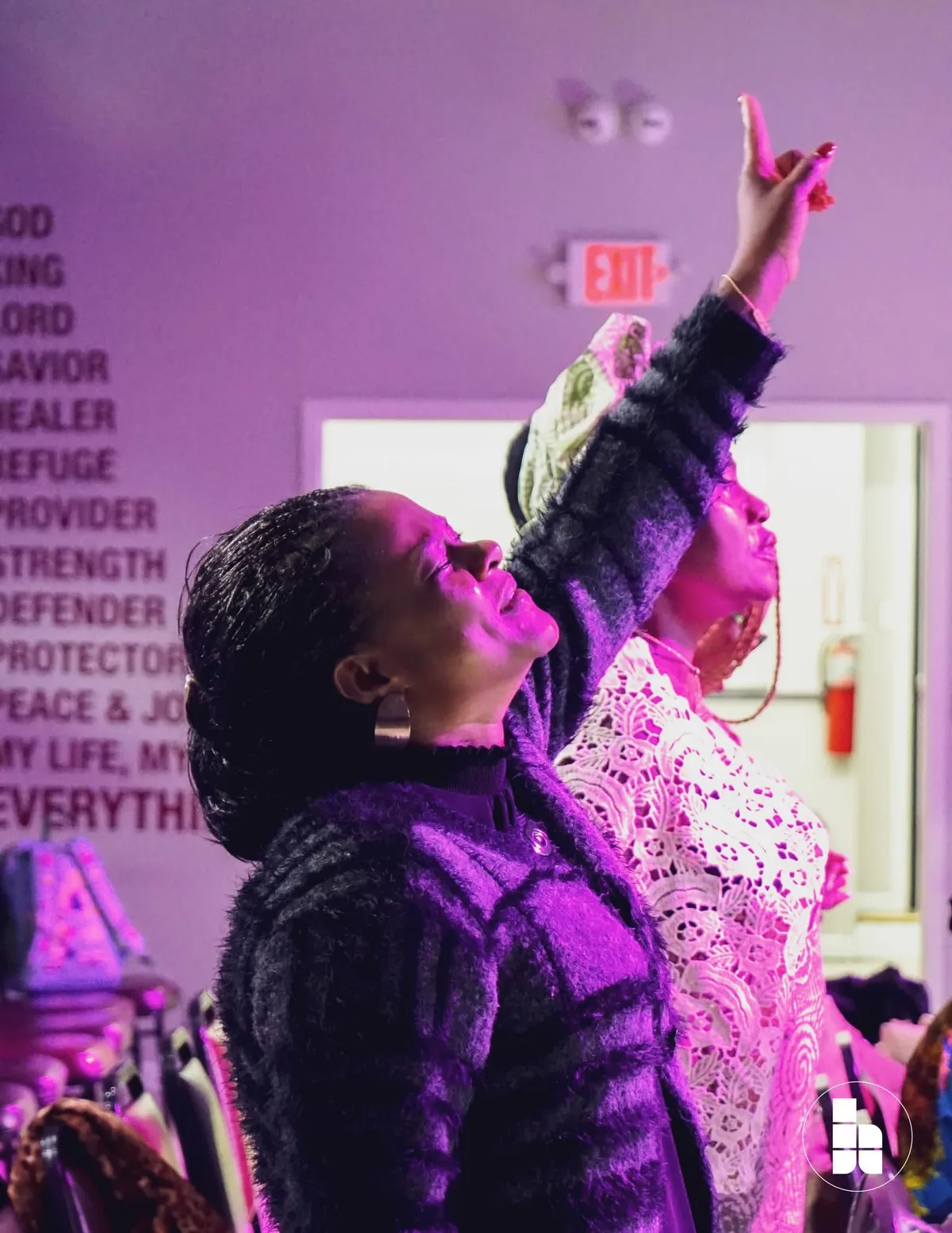 Two members worshipping with hands raised