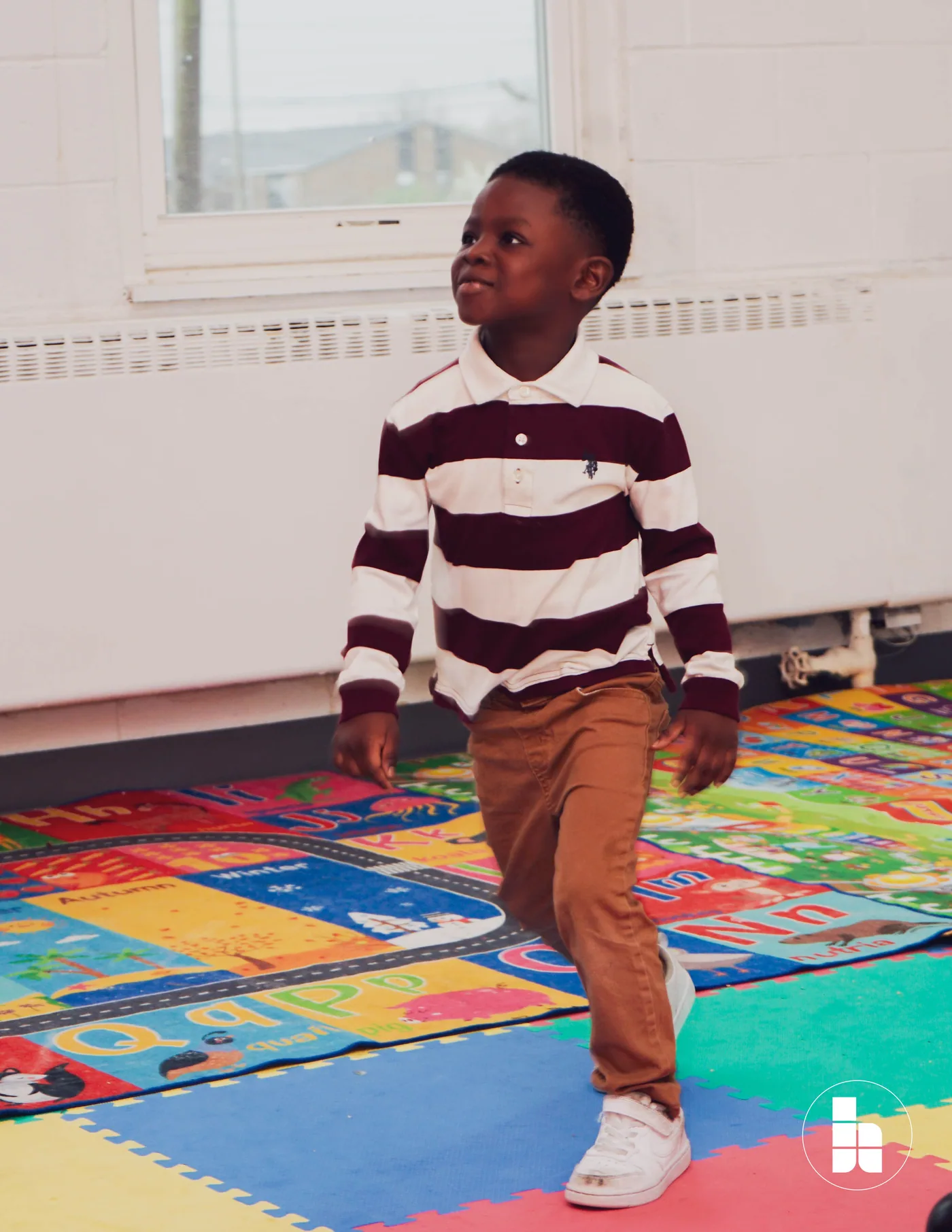 A child on the play mat in the Jubilee Kids room
