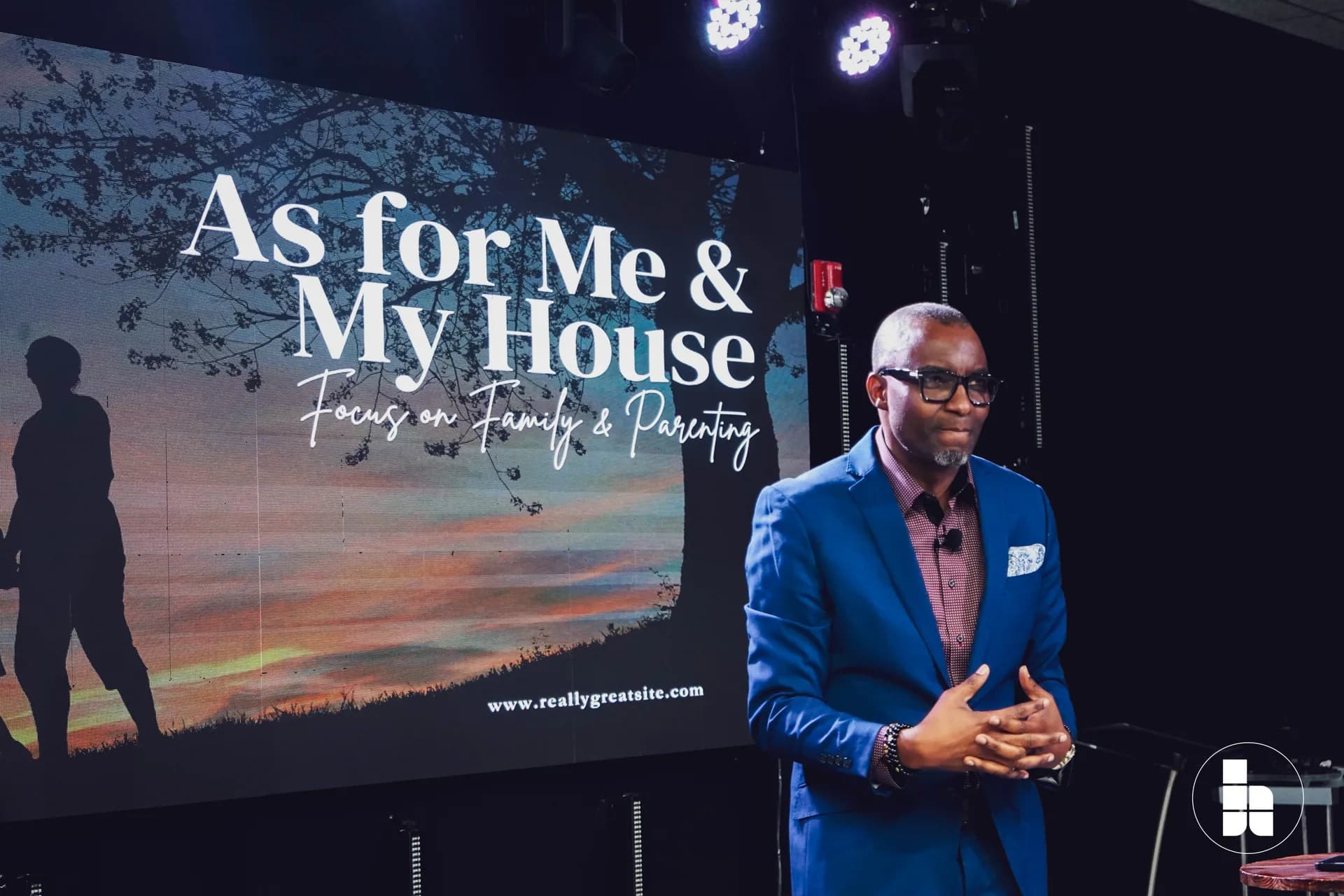 A pastor teaching from the platform at Jubilee Place